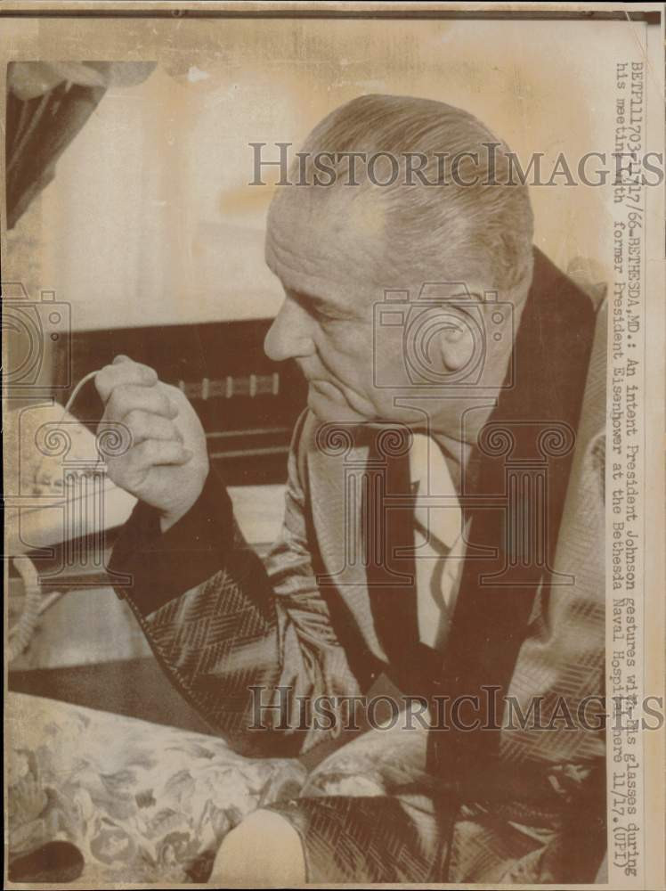 1966 Press Photo Lyndon Johnson stares at his glasses at Bethesda Naval Hospital