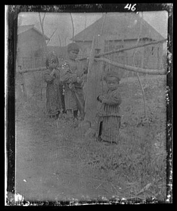 Three Ainu children,fence,villages,buildings,structures,nitrates,A Genthe,1908