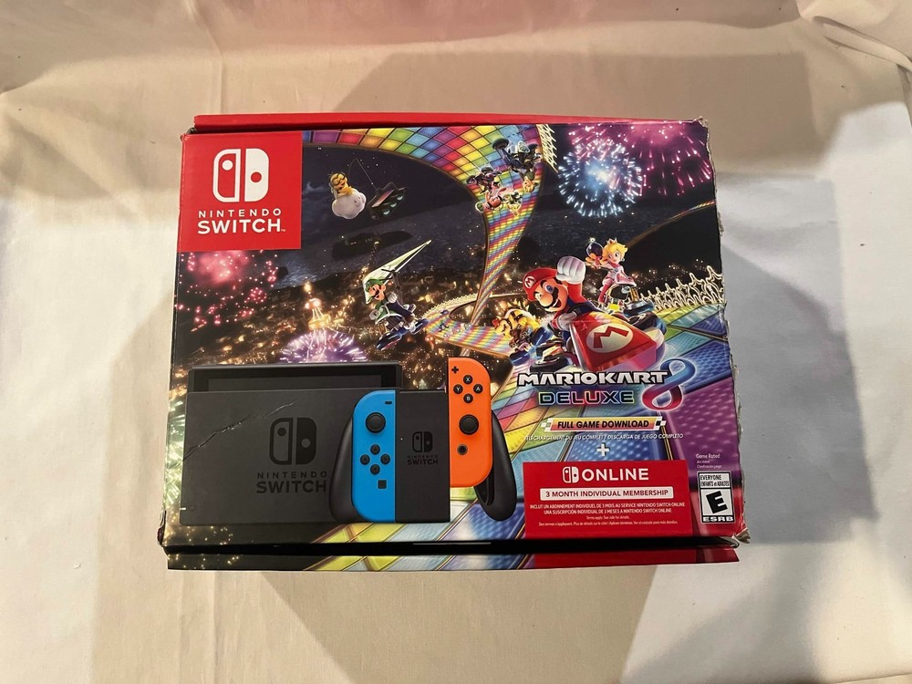 Nintendo Switch with accessories and box with red and blue joy cons