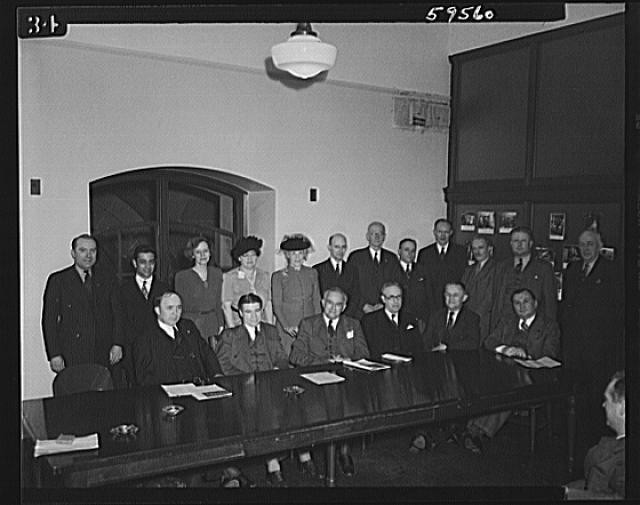 Office meeting group portrait 1935 1945 men and women conference room