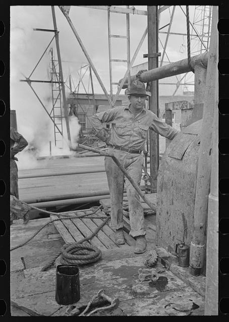 Photo:Oil field worker at derrick, Kilgore, Texas