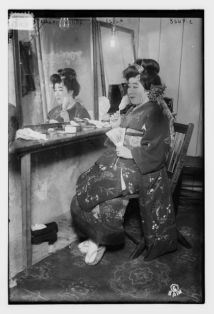 Photo:Tamaki Miura Japanese opera singer 1910s seated at mirror makeup fan