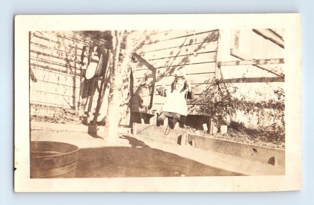 Old Vintage Photo SOLO GIRL BOW PIGTAILS IN HAIR SWINGING ON TREE SWING
