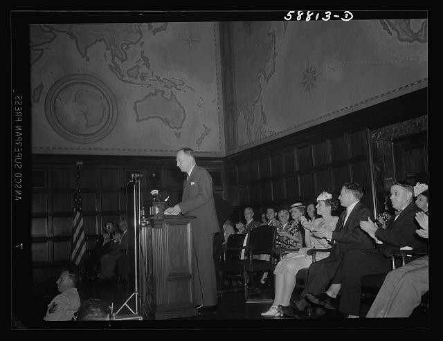 Photo:Unknown location 1930s man speaking at podium audience in hall