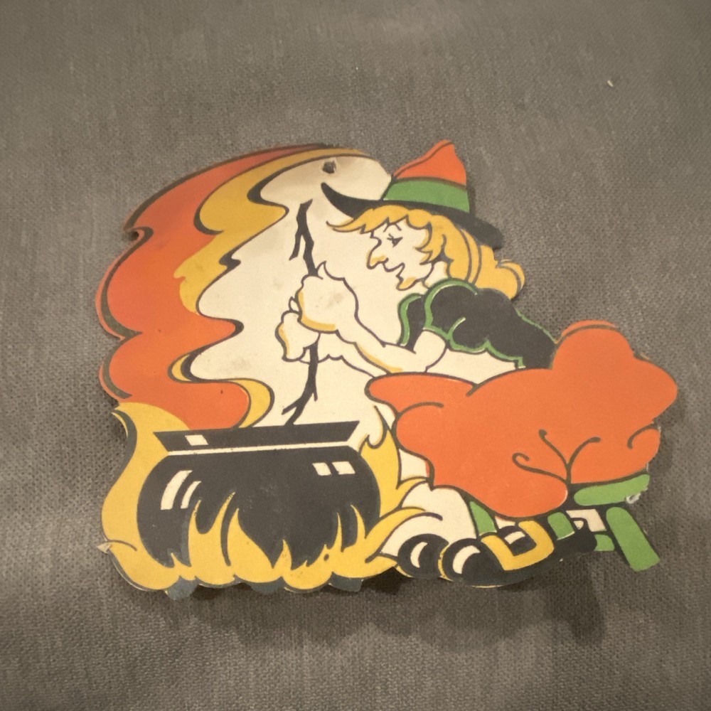 vintage 1950s Beistle halloween decoration features a witch stirring a cauldron.