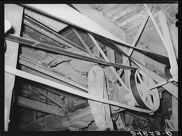 Photo:Belts and machinist. Cotton seed oil mill. McLennan County, Texas