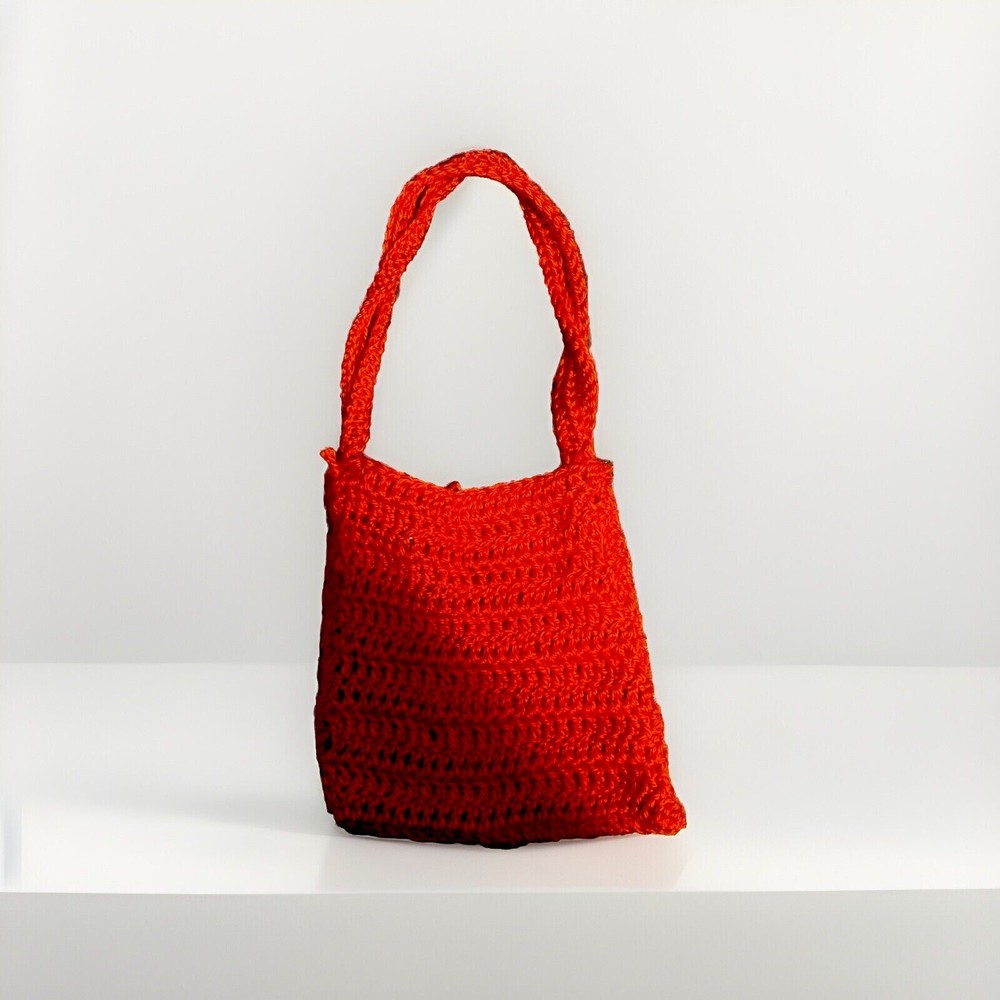 A  red handbag, can fit small Items and phone sized objects.