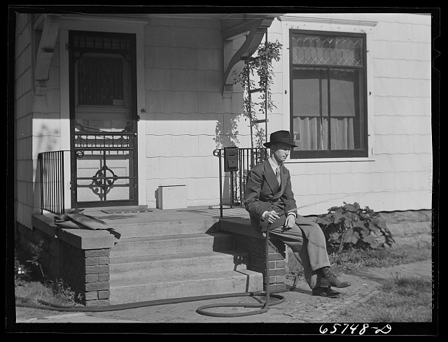 Photo:1930s Man in Suit on Porch With Garden Hose House Exterior