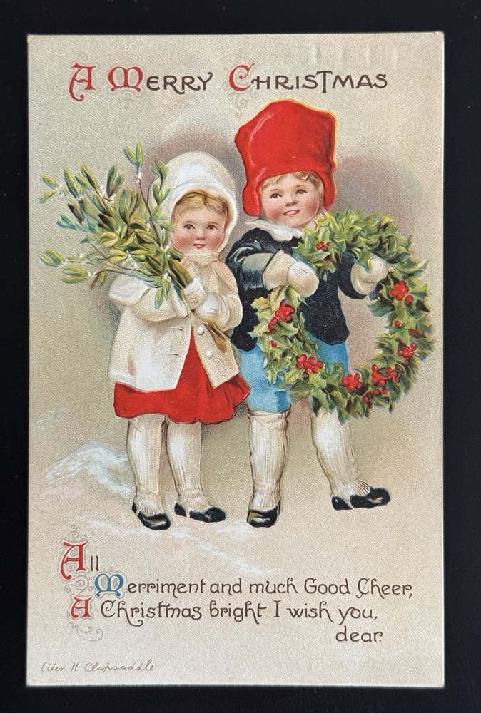 Signed Clapsaddle Boy & Girl Carry A Wreath & Mistletoe Christmas Postcard