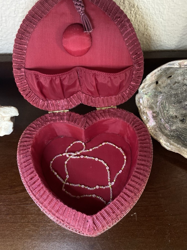 Burgundy heart-shaped jewelry or sewing box with floral ribbon accents