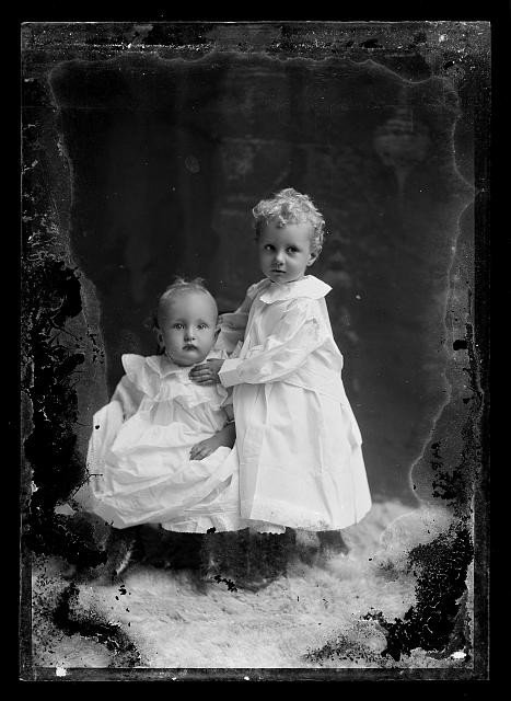 Photo:Two Young Children in White Dresses Portrait