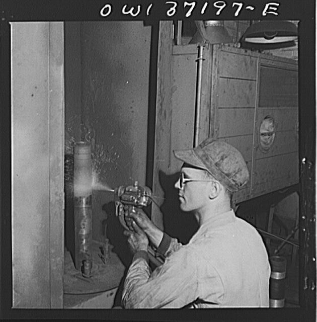 Pittsburgh, Pennsylvania. A mechanic metalizing a part in the machine shop at