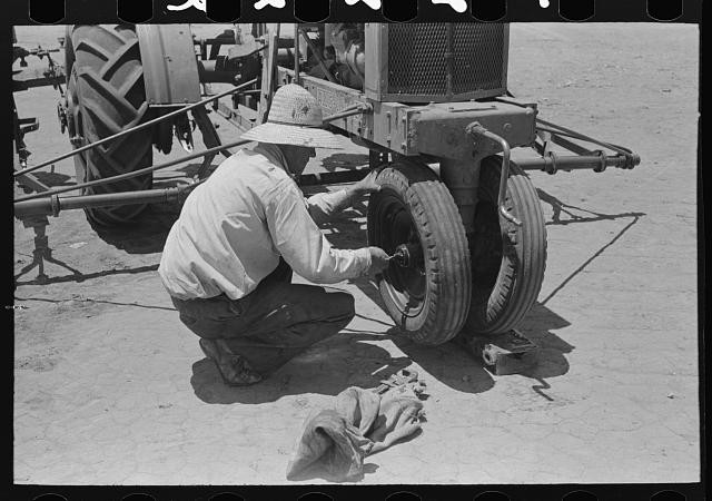 Photo:Ralls Texas 1939 Farm Laborer Tightening Tractor Wheel FSA