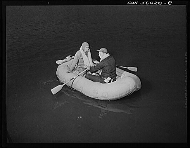 Photo:1930s Men in Inflatable Raft Rowing on Water
