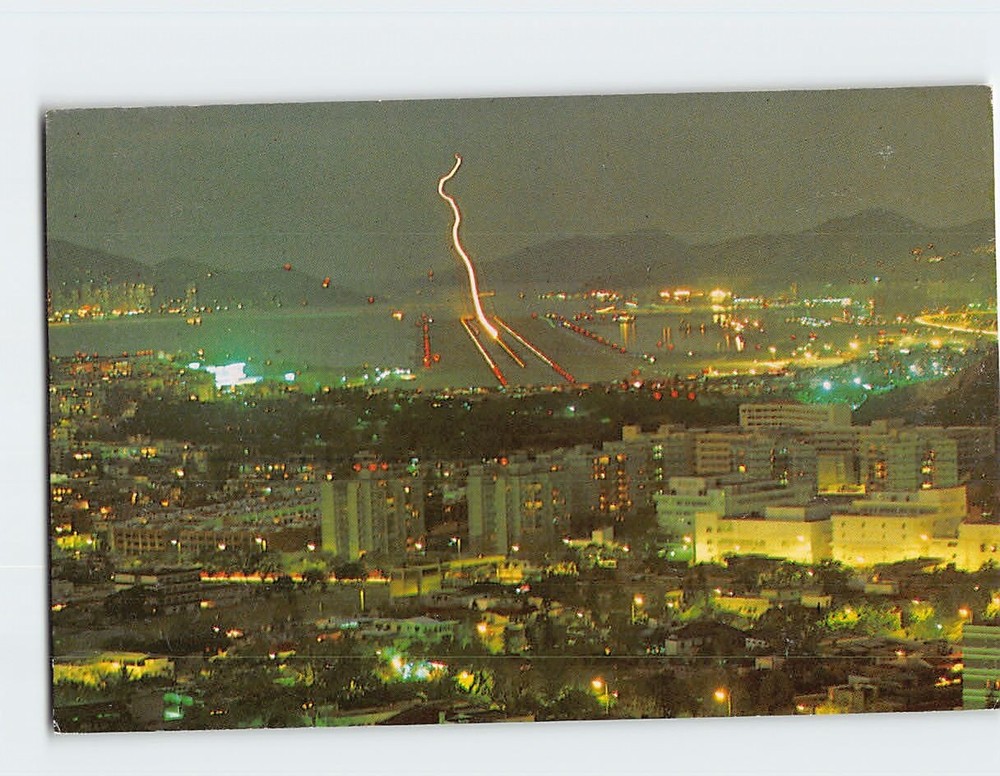 Postcard View of plane making a night landing at Kai Tak Hong Kong China