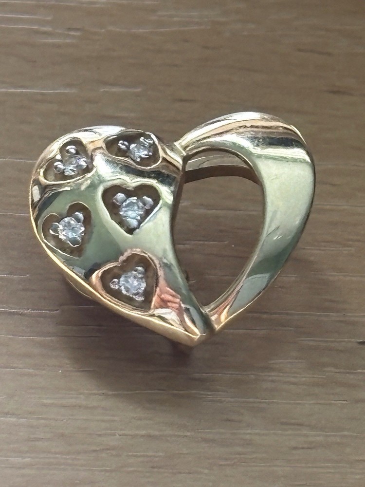 14K heart shaped diamonds pendant,DTW-.15pt,3gr.total weight,$450.00