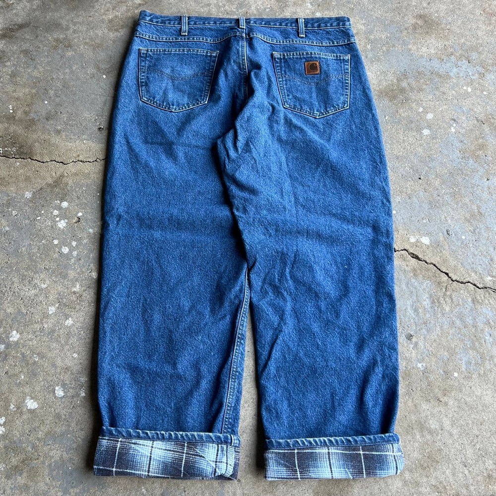 Vintage Carhartt flannel-lined denim carpenter jeans in blue workwear