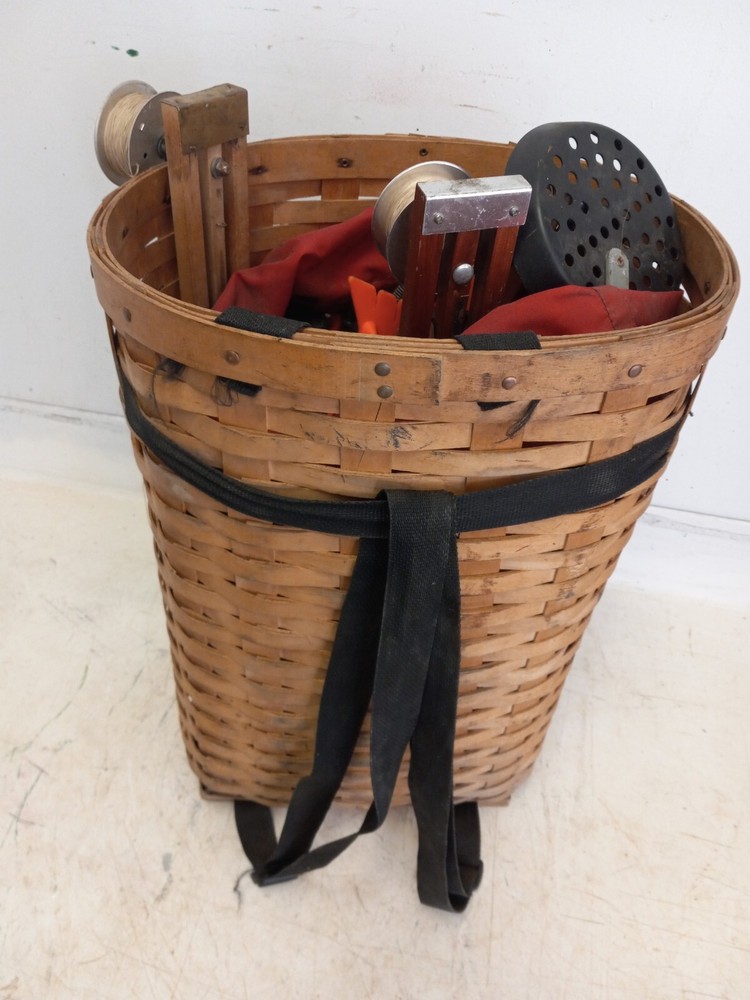 Large  24 X 15 X 12 in. Ice fishing pack basket, 16 tip ups, ice scoop very good