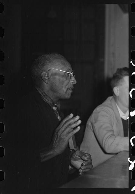 Photo:1940s Man Speaking at Table Portrait Black and White