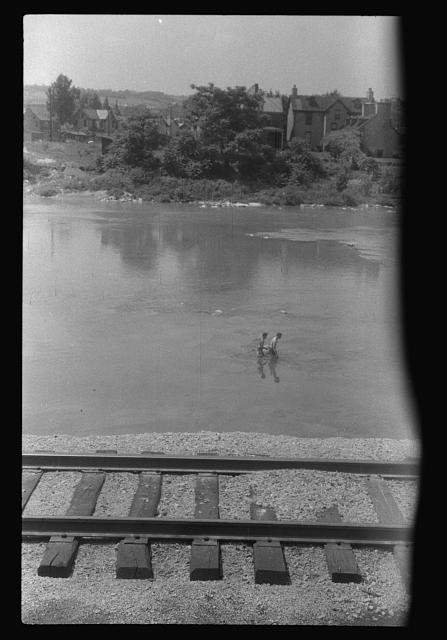 Photo:River wading children railroad tracks town houses 1930s photograph