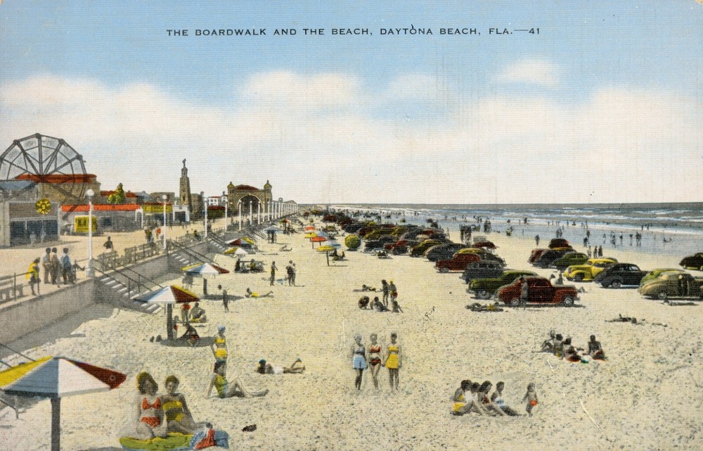 Postcard The Boardwalk and the Beach Daytona Beach Florida Sunbathers Old Cars