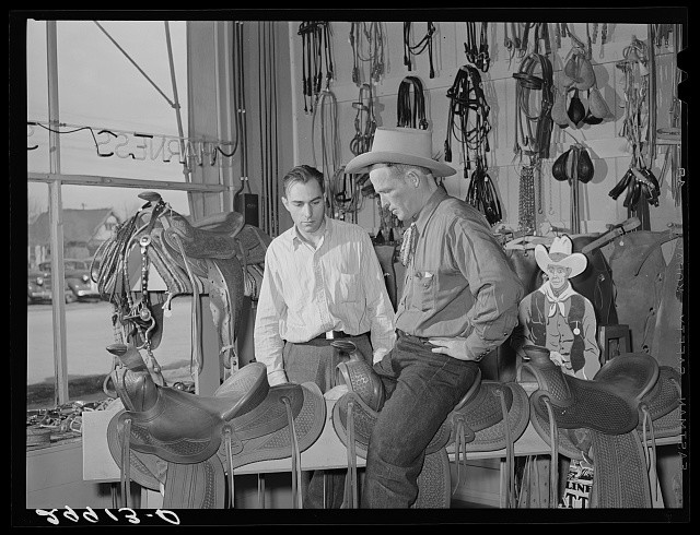Photo:Elko Nevada 1940 Cowhand Trying Saddle in Saddlery Shop