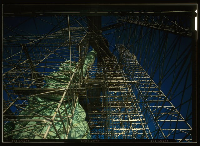 262. View looking straight up torch arm showing scaffolding and draped robe -
