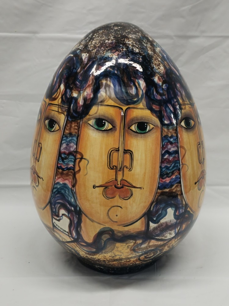 Abstract pottery faces on painted ceramic eggs-image