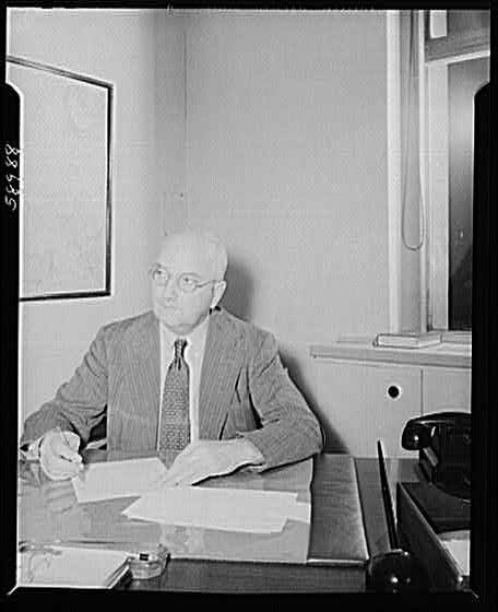Photo:Bald Man in Suit at Office Desk 1940s Black and White Portrait
