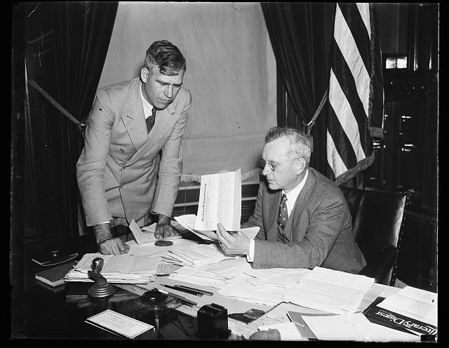 Photo:Men at Desk Documents American Flag 1930s Office Meeting