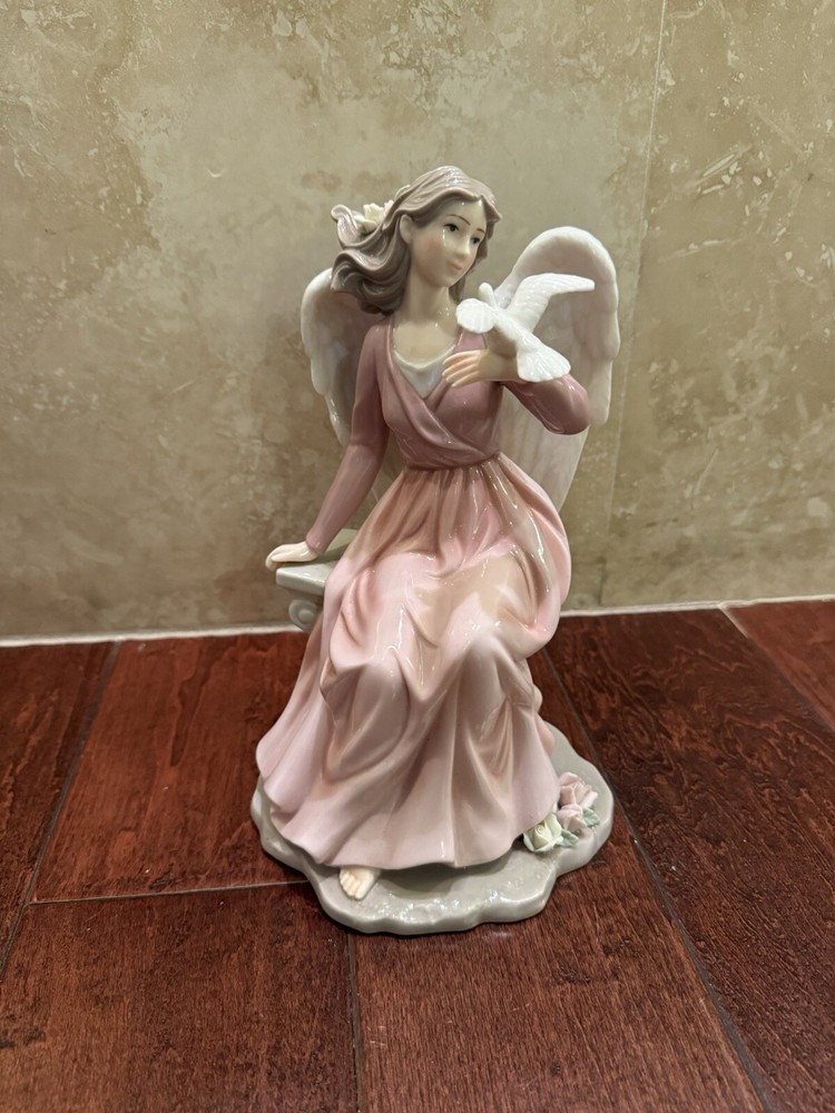 Vintage Porcelain Angel Seated on a Pedestal Holding a Dove, 10.5