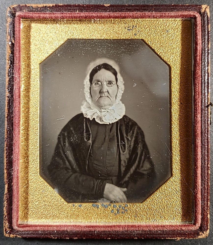 1/6 plate daguerreotype of older lady with glasses in lace cap - in half case