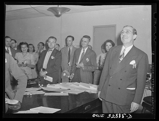 Photo:Office workers meeting 1930s 1940s men women inside room papers?