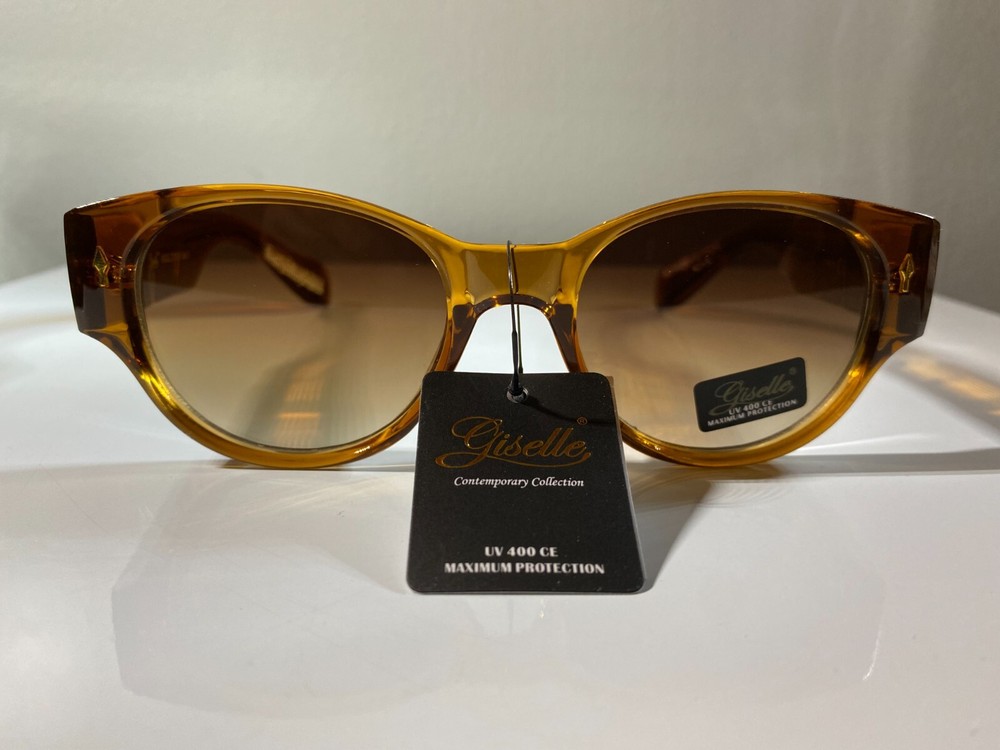 Women's cat eye style sunglasses with gold color frame and brown tinted lenses