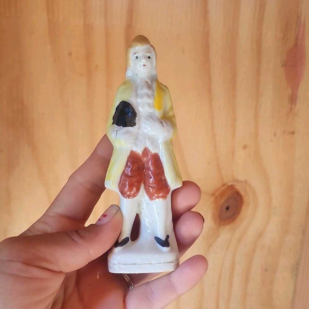 Hand-Painted Ceramic Man Figurine Yellow Coat Holding Black Hat, Glossy, 1 Pack