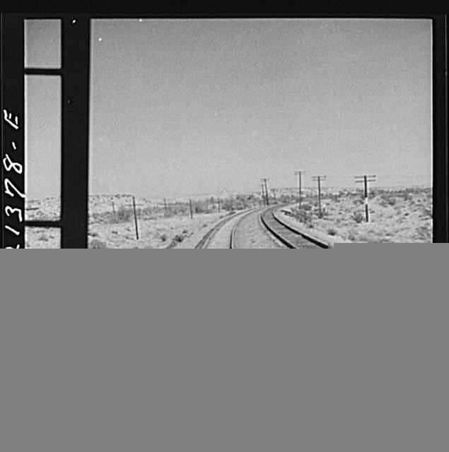 Photo:Desert Railroad Tracks Curving Through Open Landscape 1900s