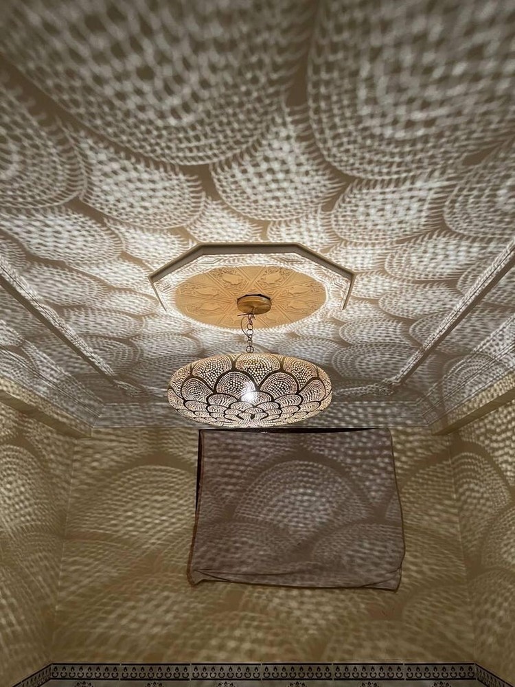 Brass Moroccan pendant light with intricate design and warm glow