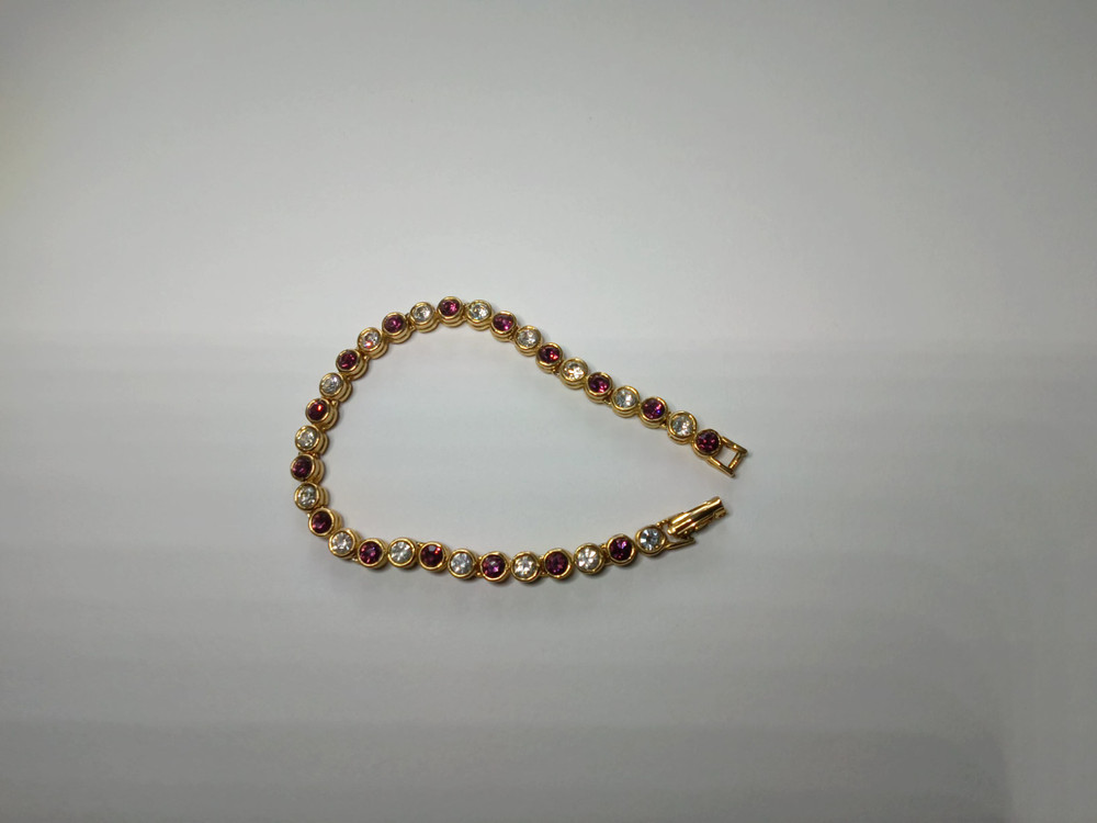 Gold Tone Tennis Bracelet with Alternating Clear and Purple Rhinestoness