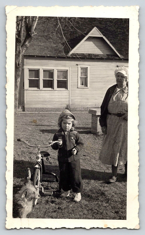 Vintage 1941 Outdoor Photo featuring Girl on Tricycle with Pet Dog and Lady by House
