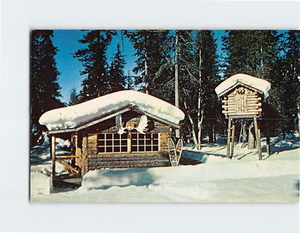 Postcard Snow covered trappers cabin and food cache Alaska USA
