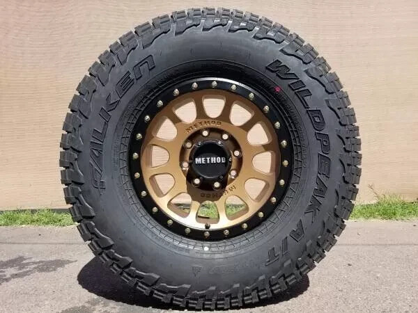 17x8.5 METHOD MR305 BRONZE WHEELS RIMS AT4W TIRES WRANGLER GLADIATOR JK JL 5x127