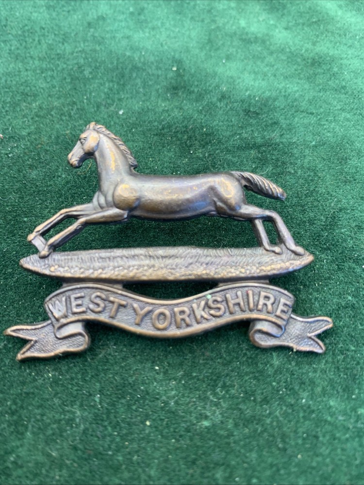 The West Yorkshire Regiment Officers Service Dress cap badge.