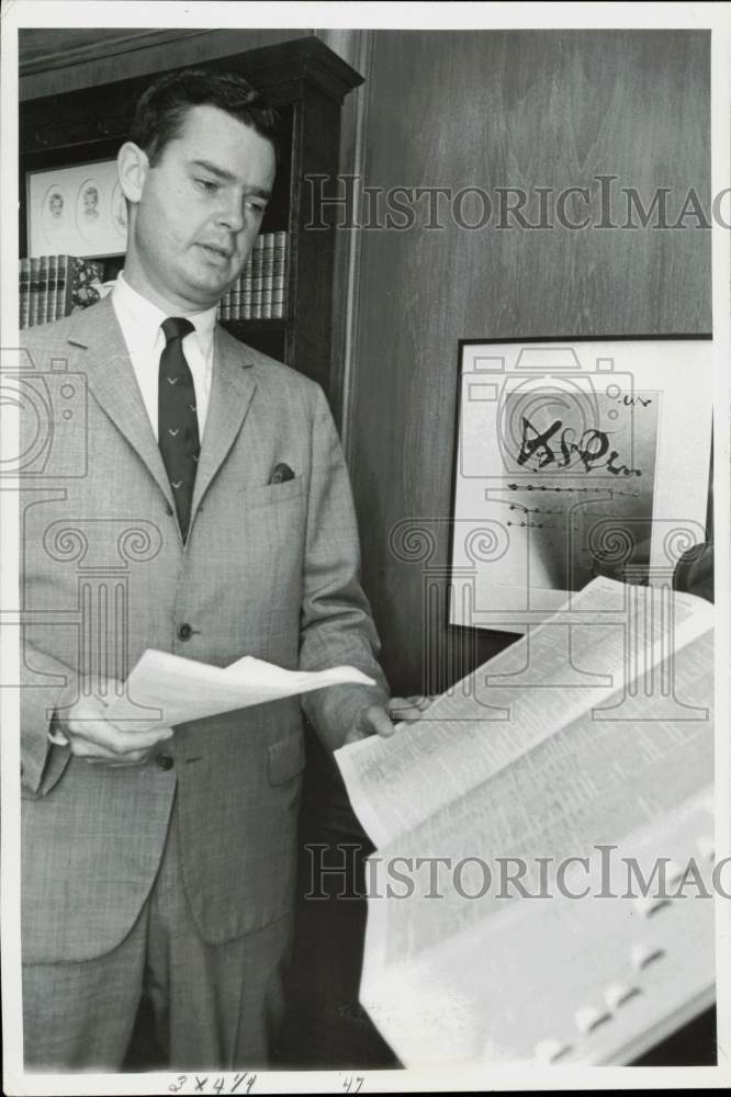 1965 Press Photo Joseph L. Hudson, Jr. checks book listings. - afa40734
