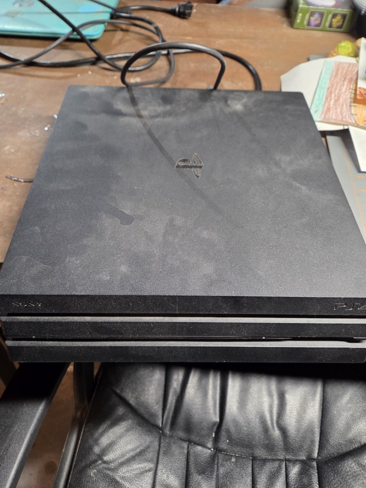 PlayStation 4 Pro with games and controllers