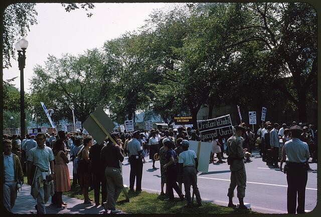 People holding signs and marching during the March on Washington,1963