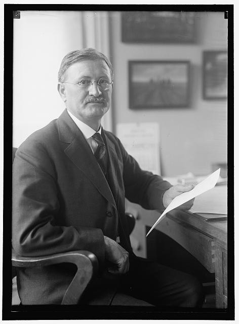 Photo:Portrait of Man at Desk in Suit with Papers 1911 1917