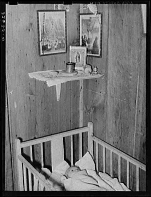 Photo:Mexican baby in corner of room. San Antonio, Texas
