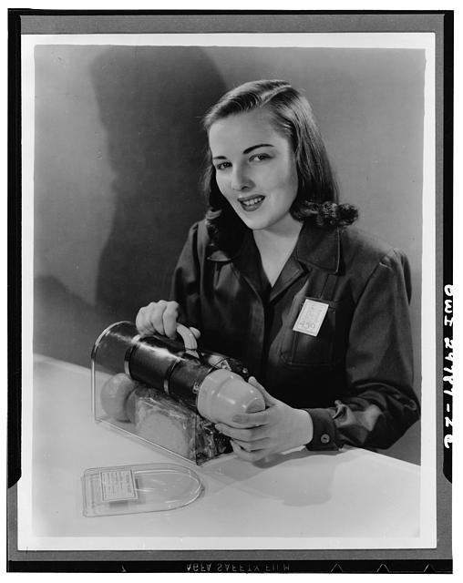 Photo:1940s Woman Holding WWII Aircraft Torpedo Or Bomb Prototype Portrait