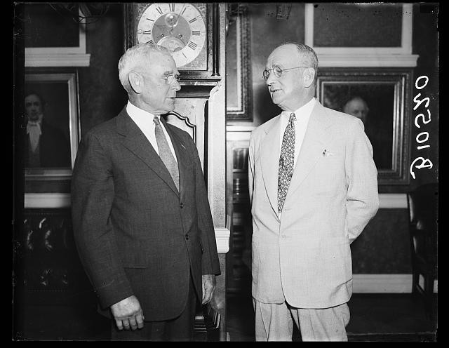 Photo:1936 Men in Suits Portrait Clock Office Interior