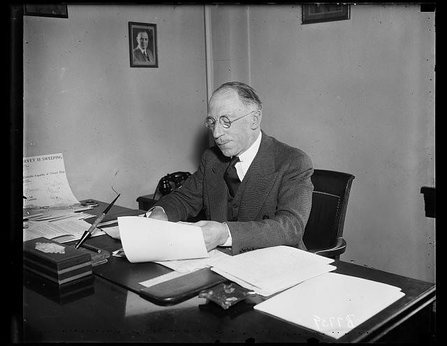 Photo:1935 Man at Desk Office Portrait Reading Papers Glasses